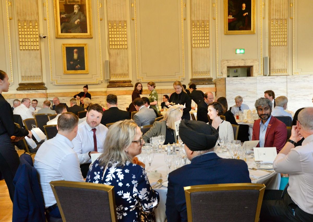 Talking with an MP at a parliamentary dinner. The APPG circuit is where sector policy gets shaped